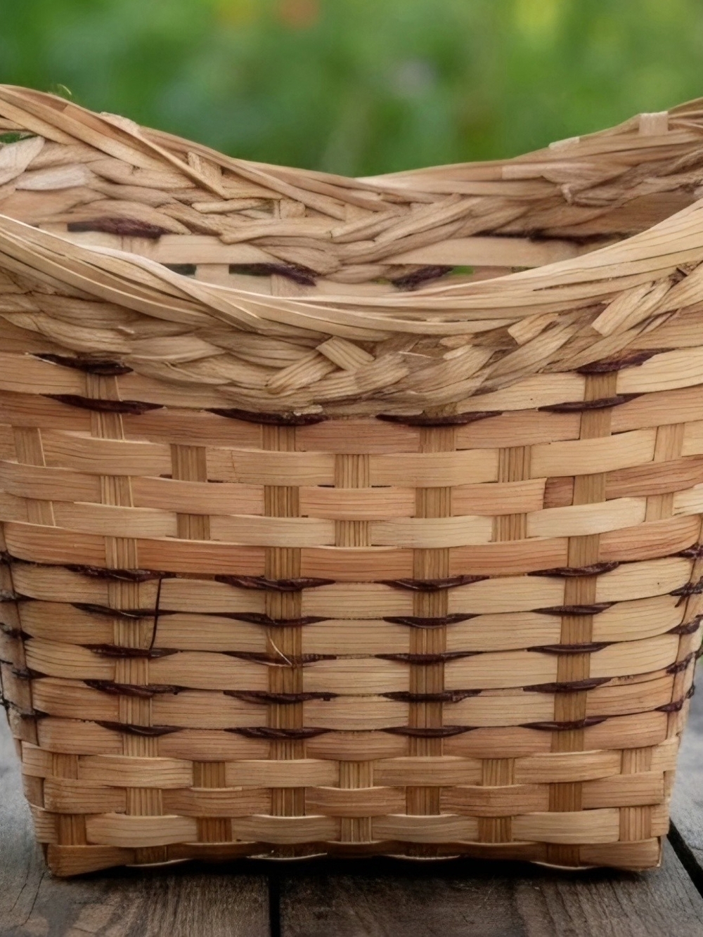 Vintage wooden splint basket featuring a woven natural finish and dipped rim.